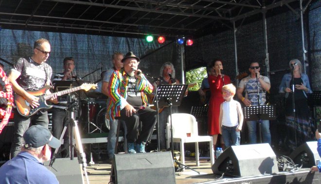 Veel succes voor Ron 'El Kroppo' Krop op het Hippiefestival. Helemaal rechts op het podium Michel en Barbara. Het jongetje op de voorgrond is de kleinzoon van Ron Krop.
